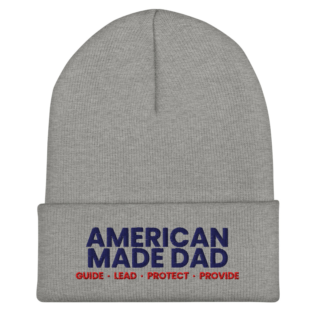 Front of a heather grey cuffed beanie with the embroidered American Made Dad compass