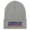 Front of a heather grey cuffed beanie with the embroidered American Made Dad compass