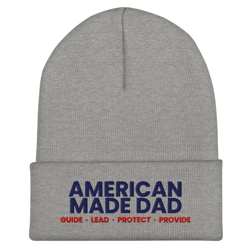 Front of a heather grey cuffed beanie with the embroidered American Made Dad compass