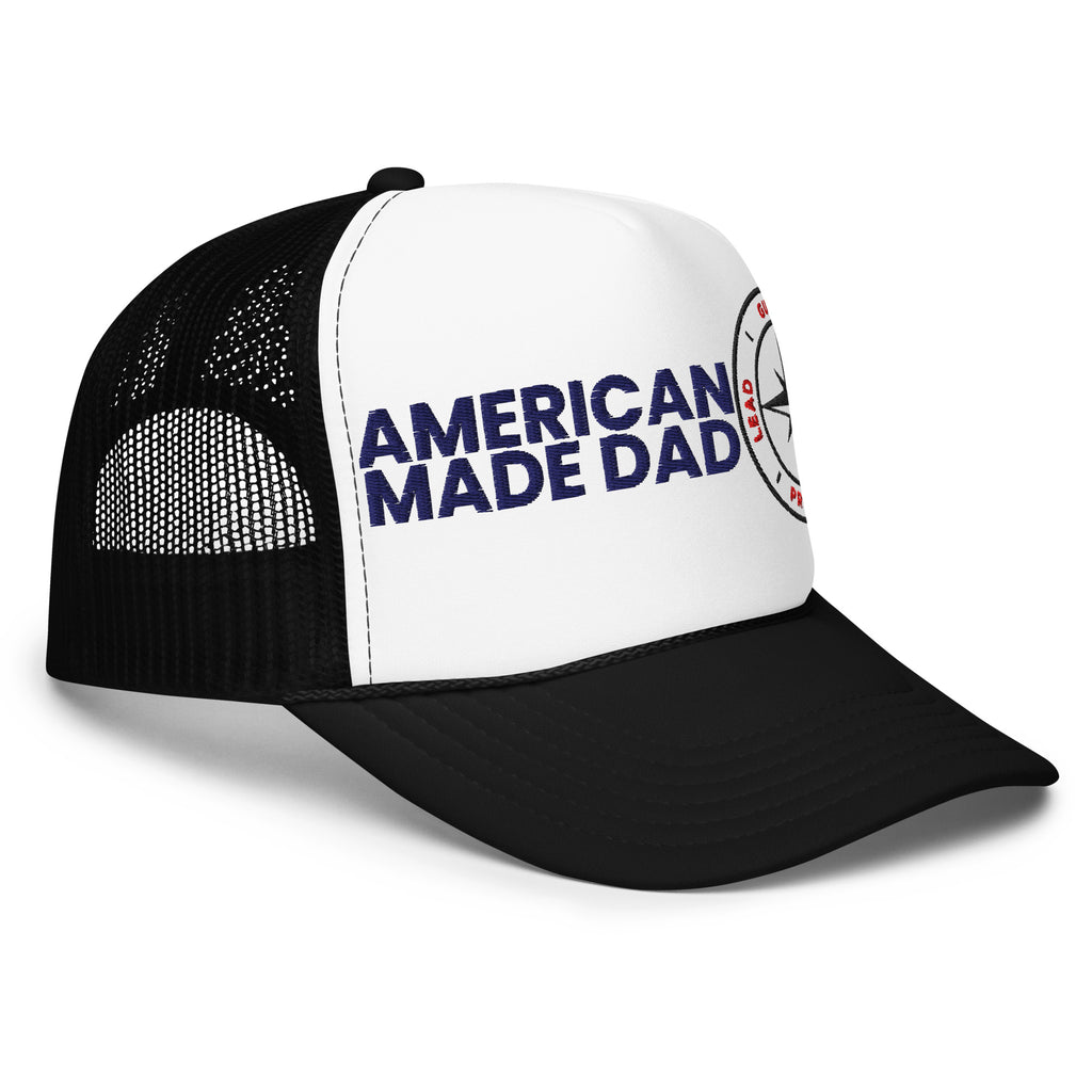 Right angle of a black and white foam trucker hat with the American Made Dad compass