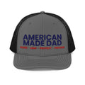 Front of a charcoal and black snapback trucker cap with the embroidered American Made Dad compass