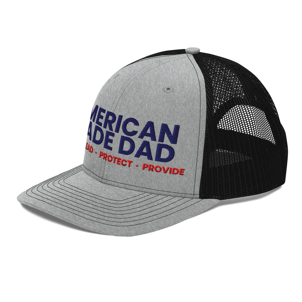 Left angle of a heather grey and black snapback trucker cap with the embroidered compass on the front