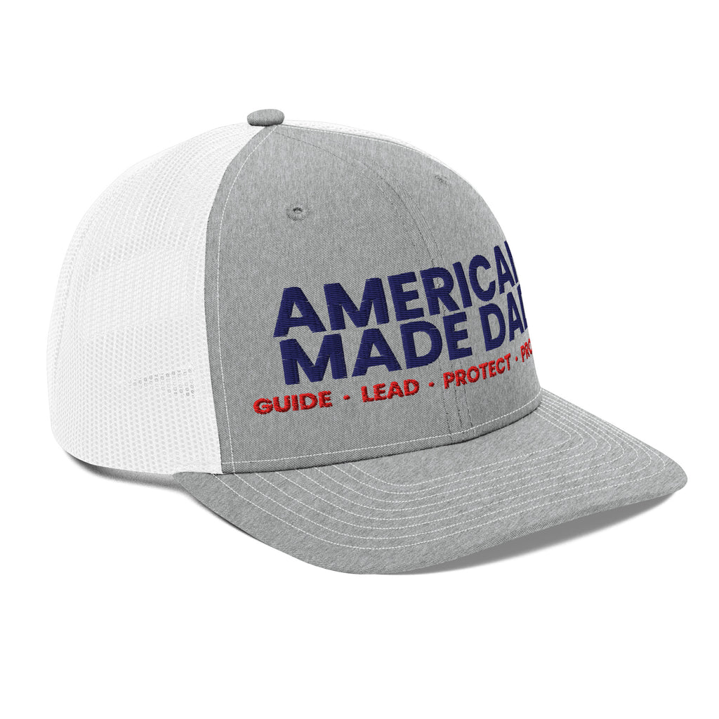 Right angle of a heather grey and white snapback trucker cap with the embroidered compass on the front