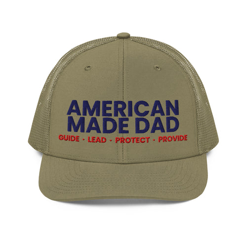 Front of a loden snapback trucker cap with the embroidered American Made Dad compass